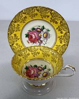 Teacup and saucer set showing top view and floral pattern inside teacup and on saucer center