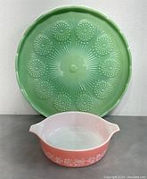 Jadeite platter and pink Pyrex bowl displayed together, showing size and color contrast