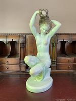 Full front view showing entire porcelain figurine and oval base