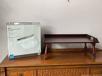 Wooden folding tray with legs beside unopened box for Diner flush mount light