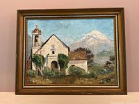 Full front view of the framed painting showing church with mountain.