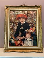 Front view of framed art print showing two children in vintage style clothing, with details of the ornate gold-colored frame and visible signs of wear such as scratches and dust.