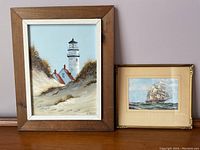 Photo showing two framed nautical art prints side by side: lighthouse and sailing ship.