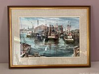 Full view of the framed art showing boats docked in Provincetown Harbor with reflections in water.
