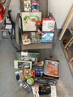 Photo showing all miscellaneous housewares and accessories arranged on and around a patio chair.