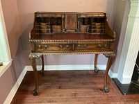 Full front view of secretary desk showing carved legs and rope trim