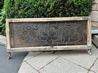 Full front view of stained glass window in wood frame