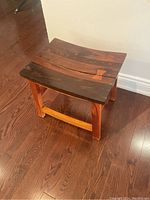 Front-top view of the hardwood stool/side table showing the curved top with a crack and butterfly joint.