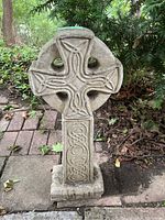 Full front view of concrete Celtic cross monument on paver base