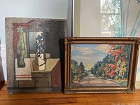 Painting pair showing two oil paintings on boards; one unframed with geometric still life, one framed with landscape.