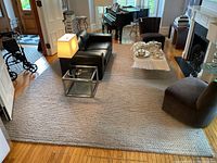 Wide view of the full rug in living room with surrounding furniture
