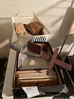 Wide view showing stereoscope on top of box with two boxes containing multiple stereoscopic view cards in the background.