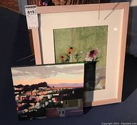 Two artworks displayed together: an oil painting of San Francisco cityscape and a framed floral pastel artwork
