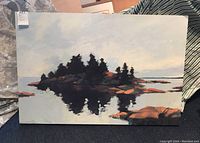 Full view of landscape painting showing island with trees and reflection on water