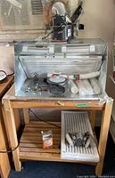 Spray booth on bench with airbrushes, filters and hose