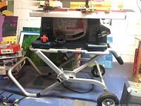 Front view of Bosch 4100 table saw mounted on wheeled TS3000 stand in basement setting