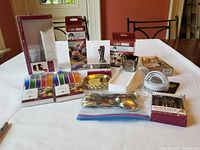 Full overview of all items in the lot arranged on a white table showing all packaged and unpackaged items