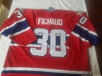 Back view of the red Hamilton Bulldogs signed jersey with the name Fichaud and number 30, showing the autograph on the number.