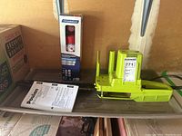 Poulan chainsaw with manual and Garrison fire extinguisher in box, boot tray underneath