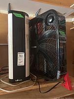 Side view of both appliances showing the Pelonis fan and EcHouzng heater side by side with size stickers.