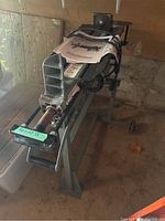 Front-angle view of horizontal log splitter showing wedge and front beam