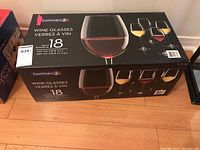 Original box of Luminarc wine glasses with product graphics showing 18 glasses and volume specification.