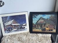 Two Coca Cola wall decor framed prints showing vintage delivery scenes, one winter night, one daytime.