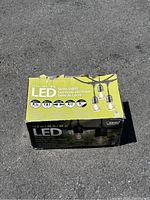 Box of FEIT Electric LED string lights showing front and top sides with product details and image of string lights.