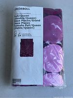 Packaged Ikea SMÖRBOLL duvet cover and pillowcase set, full/queen size, showing product label and folded bedding fabric with pink and purple circles.