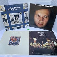 Photo of four vintage vinyl album covers including Loggins & Messina, Don McLean, and Paul Simon.