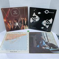 Four vintage vinyl album covers arranged in a 2 by 2 layout against white background. Top left is Mott the Hoople, top right Roy Orbison, bottom left Martha and the Muffins with a map on the cover, bottom right Carole King sitting outdoors with a dog.
