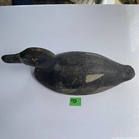 Top angle view of the Blue Bill duck decoy showing the detailed glass eyes and body paint wear.