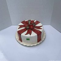 Top view of cake carrier shaped like a cake with red bow decoration