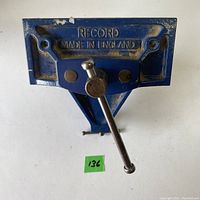 Close-up top/front view of blue Record metal bench vice with embossed branding