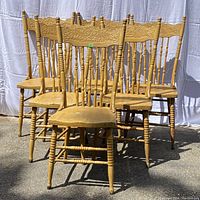 Photo of six Old Man Winter pressback chairs showing the full group, painted yellow, with visible wear