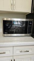 Front view of Panasonic microwave showing stainless steel exterior and digital control panel