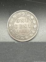 Reverse side of the coin displaying denomination and maple leaf wreath