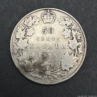 Reverse side of the 1913 Canadian 50 cents coin showing denomination and maple leaf wreath.