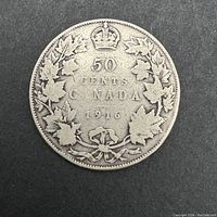 Reverse of the 1916 Canadian 50 cents coin showing denomination, country, date and decorative maple leaves with crown.