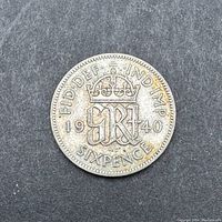 Reverse of 1940 British sixpence coin with crowned 'GRI' monogram, date, and denomination.