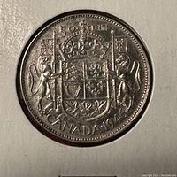 Reverse side of the 1946 Canadian 50 cents coin showing the Canadian coat of arms with denomination and year.