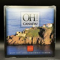 Front of sealed Oh Canada 2004 coin set packaging showing coastal scenery and branding