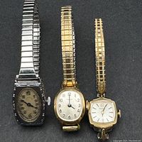 Three ladies wristwatches laid side by side showing overall condition and dial faces