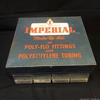 Top view of blue metal box with Imperial branding and orange lettering detailing it is a make-up kit for Poly-Flo fittings and polyethylene tubing.