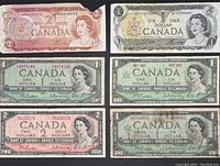 Top-down photo showing six Canadian paper currency notes in circulated condition, including $1 and $2 denominations from mid-20th century.