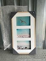 Photo of the new wooden 3-photo frame with white matting and a light natural wood finish, standing upright.