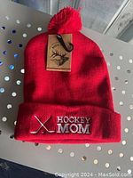 Red knit beanie hat with pom-pom, 'Hockey Mom' embroidered on cuff, new with White Oak tag attached.