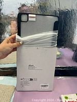 Back view of the black protective case showing camera cutout and packaging with JETech branding.