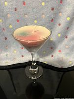 Side view of the martini glass candle showing the glass shape and candle colors.