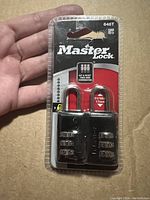 Photo shows two unopened Master Lock combination padlocks still in original packaging featuring 4-digit combination and 17mm stainless steel shackle.